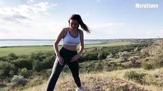 A girl is having fun with her boyfriend outdoors, testing her athletic skills