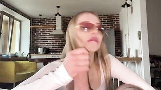 A sexy girl in glasses gets a cumshot right on her face