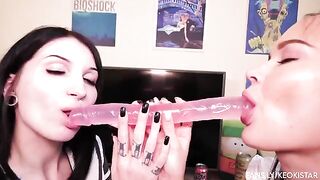 Two lesbian beauties fuck each other with a double-ended dildo, showcasing their juicy pussies in action