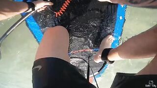 A beautiful girl is having sex with me on a surfboard in the ocean