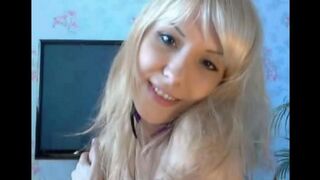 A blondie caresses her pussy with her fingers and moans