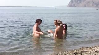 Three naked beauties on the public beach crest