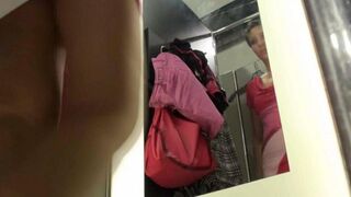 A peeping tom secretly films a girl undressing in the locker room