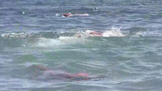 A mature woman gets undressed on the seashore