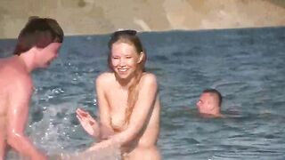 A mature woman gets undressed on the seashore