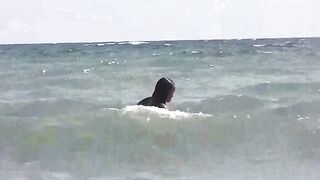 Two girls are sunbathing naked on the beach wearing no swimsuits