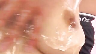 Oiled Japanese girl masturbates her boobs with her fingers in a sensual way