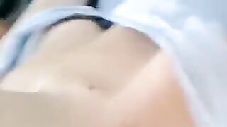 A half-naked girl lies and caresses her body with her hands in a sensual act