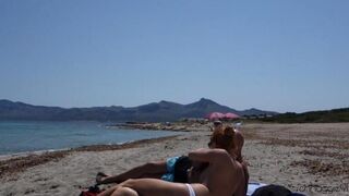 Blowjob in public on the nude beach, ending with a cumshot of cum