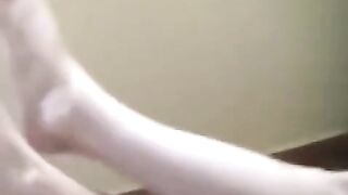 A naked girl with big natural tits is smoking on the sofa