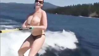 Topless beauty riding on the water skiing is a very erotic view