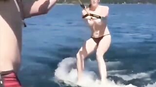 Topless beauty riding on the water skiing is a very erotic view
