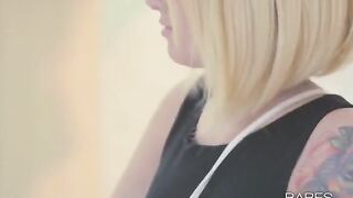 A blonde girl with sexy tattoos has fun with herself