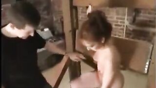 A sexy girl in bondage is being fucked by her sadistic sex slave master