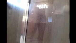 A man washes his body in the shower, but he does not know that he is being filmed