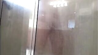 A man washes his body in the shower, but he does not know that he is being filmed