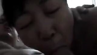 An adult Chinese woman practices her blowjob skills with enthusiasm