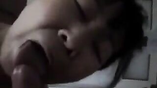 An adult Chinese woman practices her blowjob skills with enthusiasm