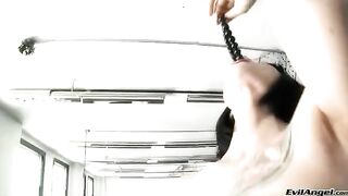 Wearing sexy heels, she plays with her balls