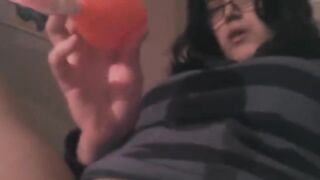 The girl caresses her clitoris with a vibrator on the bed