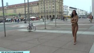 Nude girl is walking on the city streets and showing her ass