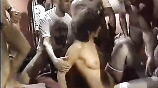 A young whore is having fun with a bunch of guys in a circle