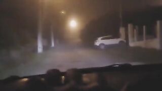 A sexy lady in white was filmed at a crossroads, showcasing her curves