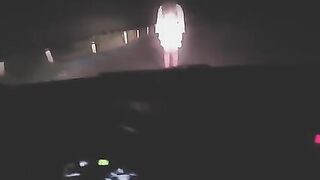 A sexy lady in white was filmed at a crossroads, showcasing her curves