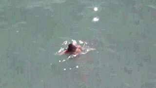 A pair of naturists have fun on the sea