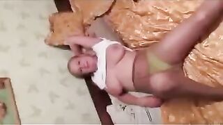 A pregnant woman is showing her boobs to the photographer