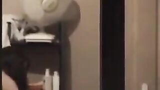 He admires to himself in the mirror, completely naked