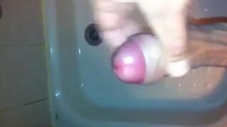 The kid caresses his dick under the shower jet stream