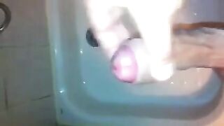 The kid caresses his dick under the shower jet stream