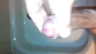 The kid caresses his dick under the shower jet stream