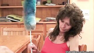 A mature woman plays with her vagina using a toy