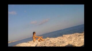 Nude sunbathing on the beach is a very pleasant pleasure