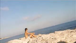 Nude sunbathing on the beach is a very pleasant pleasure