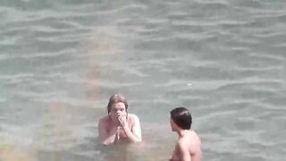 Nude beauties have fun in the sea water