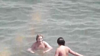 Nude beauties have fun in the sea water