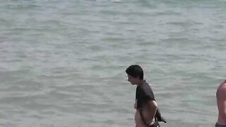 Nude beauties have fun in the sea water