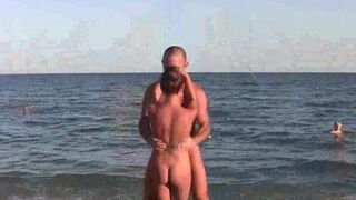 A group of acrobats have fun on the naked beach