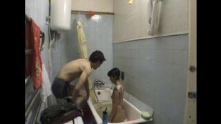 A girl is having fun with her stepbrother in the bathroom