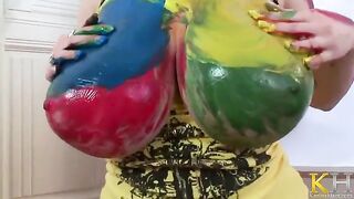 A very nice woman with big tits is painting and playing with herself