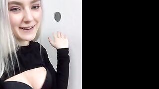 A young woman received a cumshot on her face through the glory hole in a steamy fitting room scene