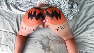 The guy smashed a pumpkin and caressed the girl’s body with it