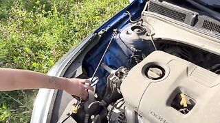 A fit girl with a perfect body had to fix her car
