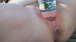 A daring act of urination in public, showcasing a gaped pussy