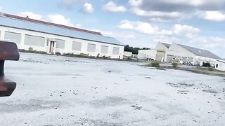 A girl is having fun in an unusual place with a big gun